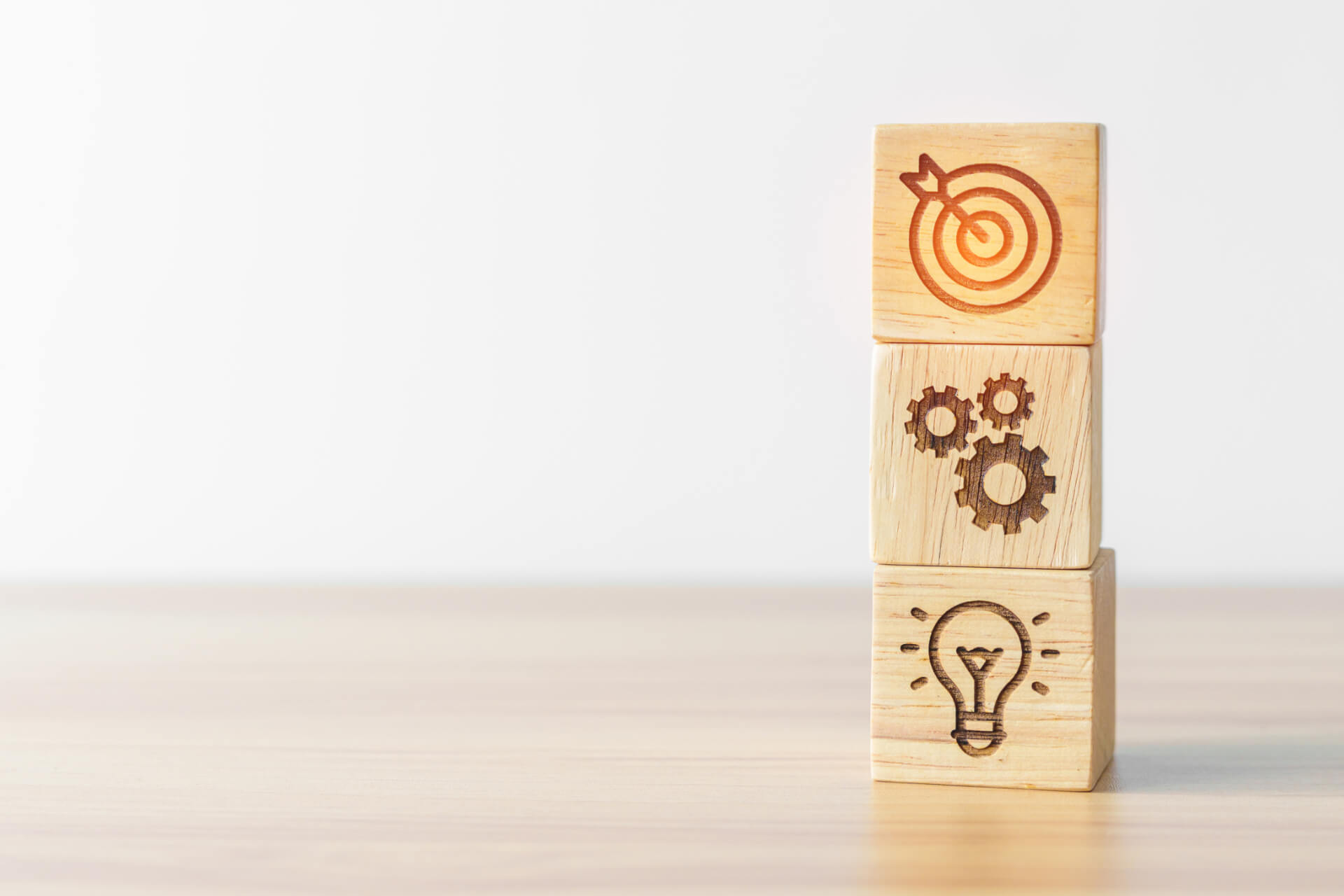 wooden blocks with bulb, cogs and target icons