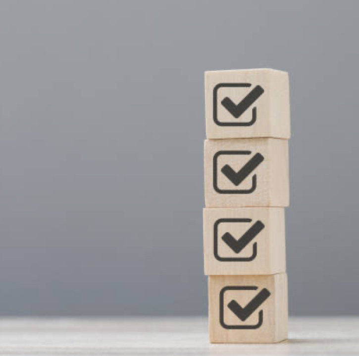 four wooden blocks with tick icons